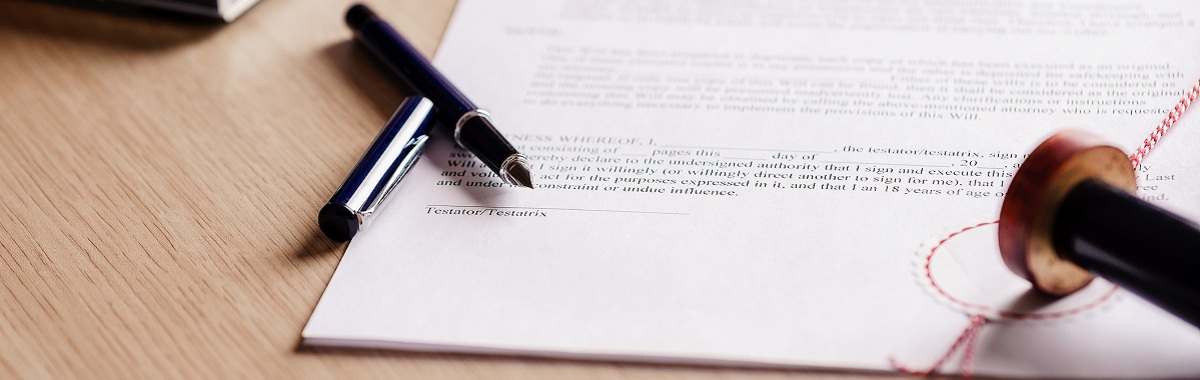 Notary pen lying on testament.